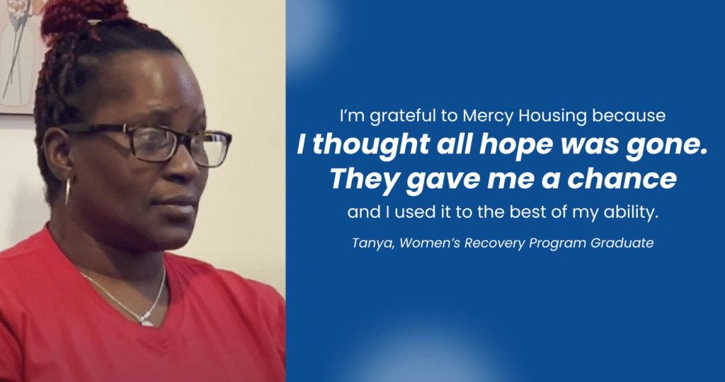 A woman in a red shirt wearing glasses saying "I'm grateful to Mercy Housing because I thought all hope was gone. They gave me a chance and I used it to the best of my ability."